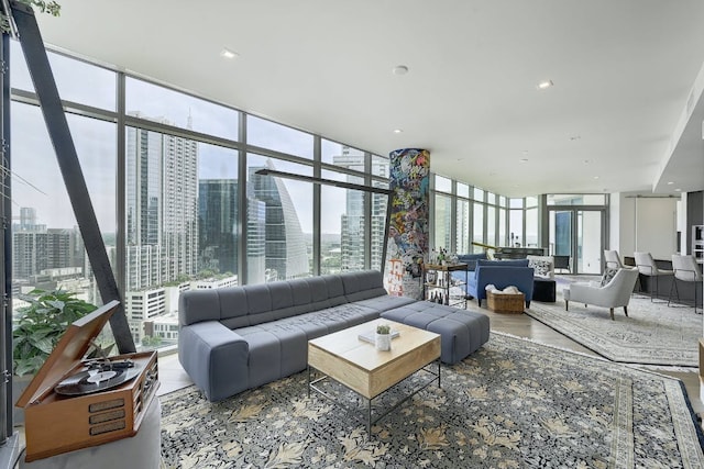 living room featuring expansive windows, a wealth of natural light, and a city view
