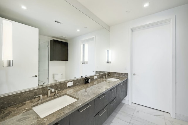full bathroom featuring a sink, toilet, marble finish floor, and visible vents