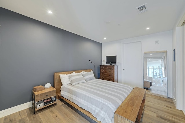 bedroom featuring recessed lighting, baseboards, visible vents, and wood finished floors