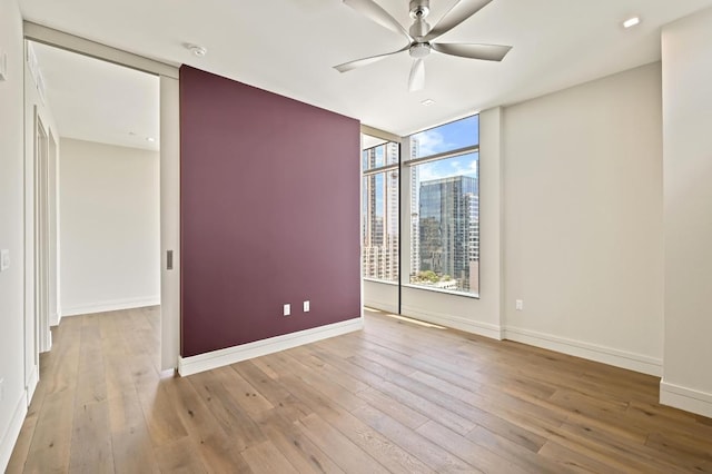 501 W Ave Unit 2001, Austin, TX 78701 - empty room featuring a ceiling fan, hardwood / wood-style flooring, a view of city, and floor to ceiling windows