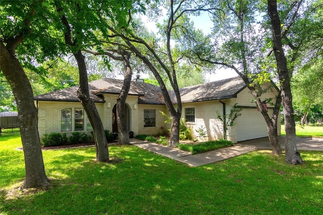 single story home with brick siding, an attached garage, driveway, and a front lawn