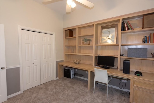 carpeted home office featuring ceiling fan and built in desk