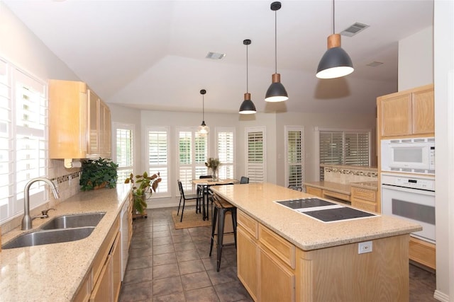 307 Deer Trace Cv, Cedar Park, TX 78613 - kitchen with white appliances, light brown cabinets, backsplash, a kitchen island, and light stone countertops