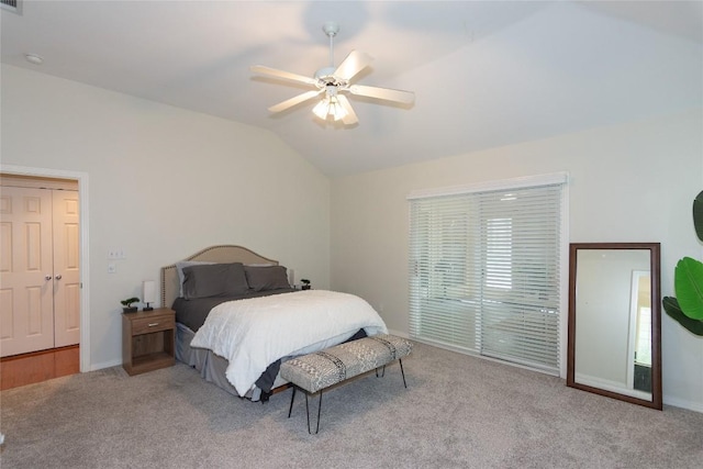 carpeted bedroom with baseboards, ceiling fan, and vaulted ceiling