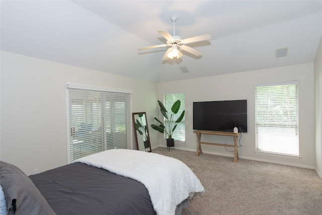 bedroom with baseboards, light colored carpet, ceiling fan, and visible vents