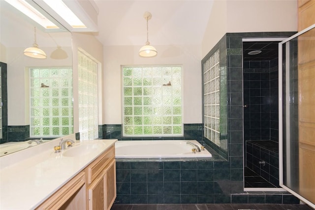 full bath featuring a shower stall, a garden tub, and vanity
