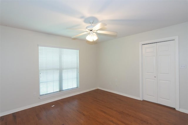 spare room with a healthy amount of sunlight, ceiling fan, and wood finished floors