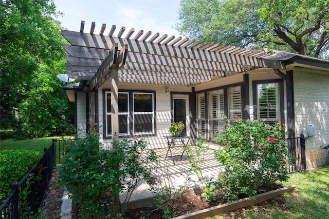 back of property with fence, a pergola, a patio, and brick siding