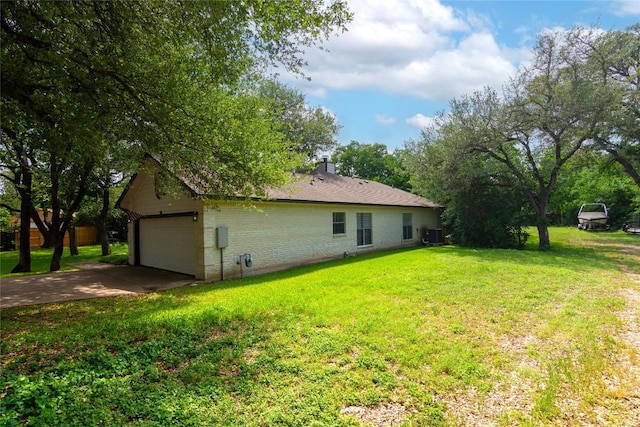 view of property exterior featuring driveway, a chimney, a lawn, brick siding, and an attached garage