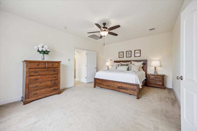 bedroom with baseboards, light colored carpet, and visible vents