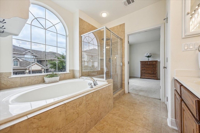bathroom featuring visible vents, vanity, tile patterned floors, a bath, and a shower stall