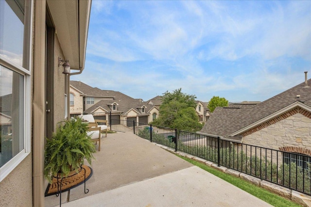 view of patio featuring fence and a residential view