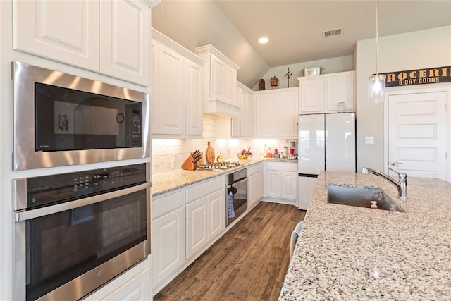 3105 High Meadow St, Seguin, TX 78155 - kitchen with appliances with stainless steel finishes, a sink, white cabinets, tasteful backsplash, and light stone countertops