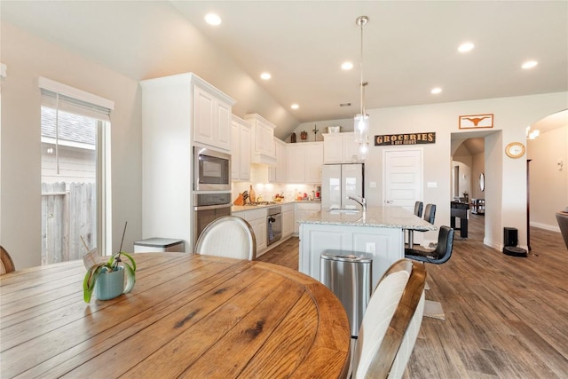 3105 High Meadow St, Seguin, TX 78155 - dining room featuring arched walkways, wood finished floors, recessed lighting, vaulted ceiling, and baseboards