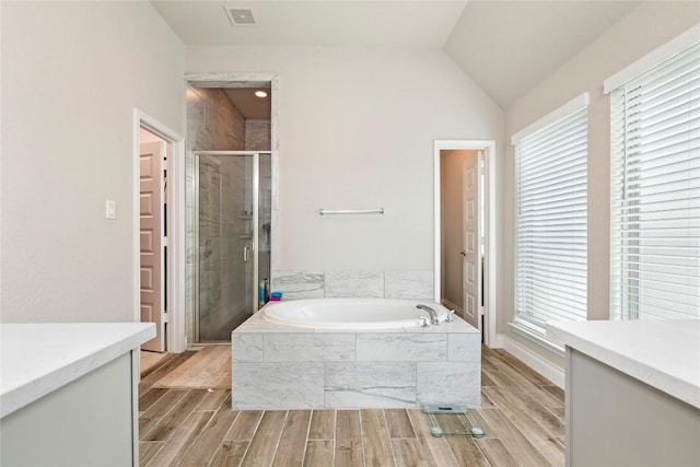 3105 High Meadow St, Seguin, TX 78155 - bathroom featuring vanity, a garden tub, a stall shower, wood tiled floors, and vaulted ceiling