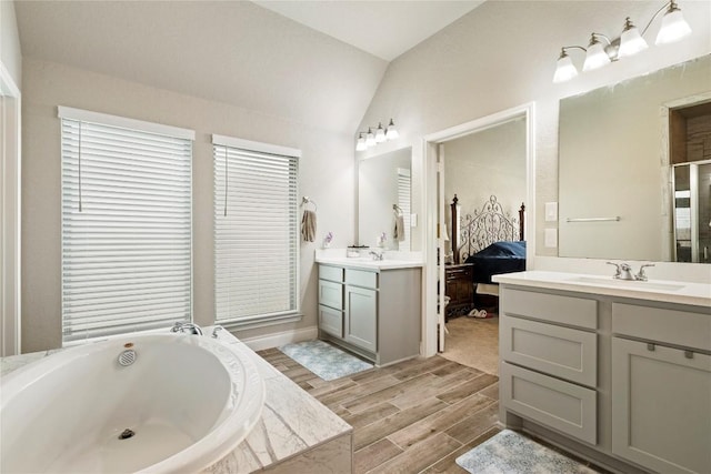 3105 High Meadow St, Seguin, TX 78155 - bathroom with lofted ceiling, two vanities, a bath, wood tiled floors, and ensuite bath