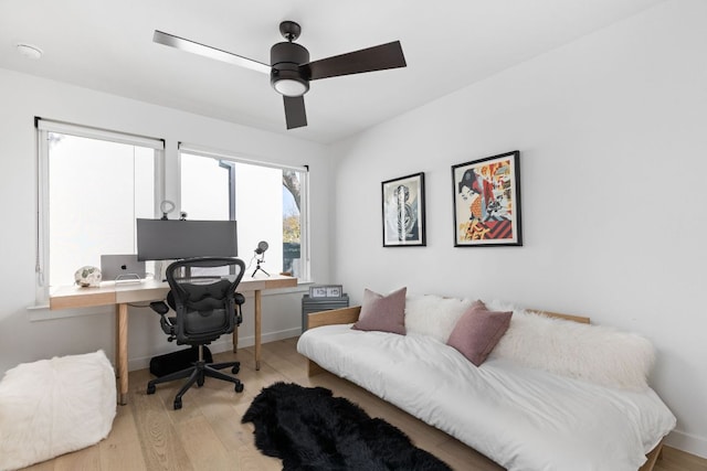 home office with baseboards, ceiling fan, and wood finished floors
