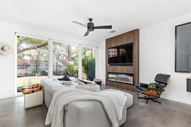 631 Tillery St Unit 1, Austin, TX 78702 - living area featuring concrete floors, a fireplace, and a ceiling fan