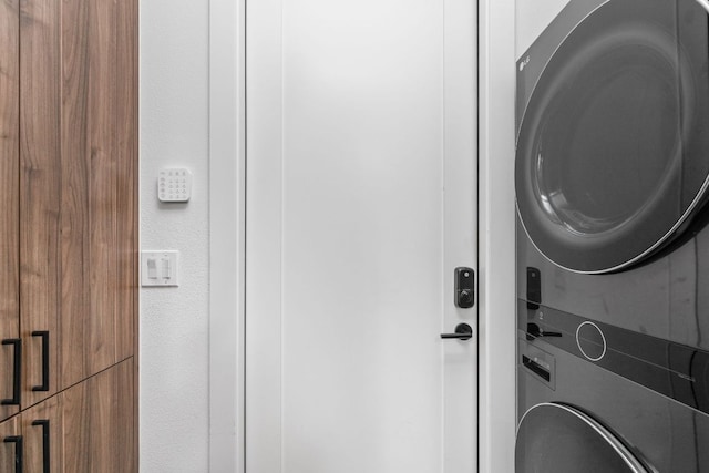 laundry room featuring stacked washer and dryer