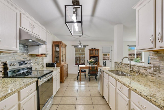 kitchen with light tile patterned floors, under cabinet range hood, a sink, appliances with stainless steel finishes, and backsplash