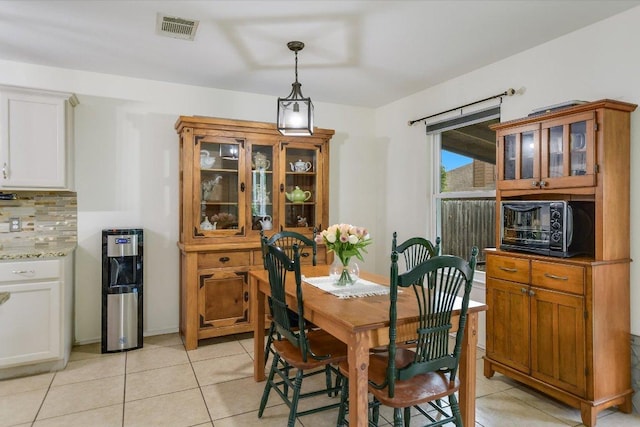 dining area with visible vents, a toaster, and light tile patterned flooring