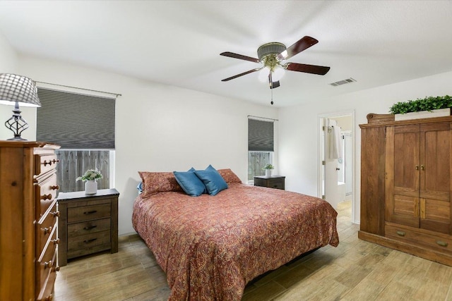 3006 Tyler Ln, Taylor, TX 76574 - bedroom featuring light wood finished floors, ensuite bath, and ceiling fan