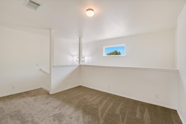 carpeted empty room with visible vents and baseboards