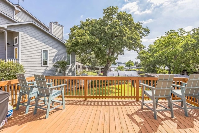 deck featuring fence and a yard