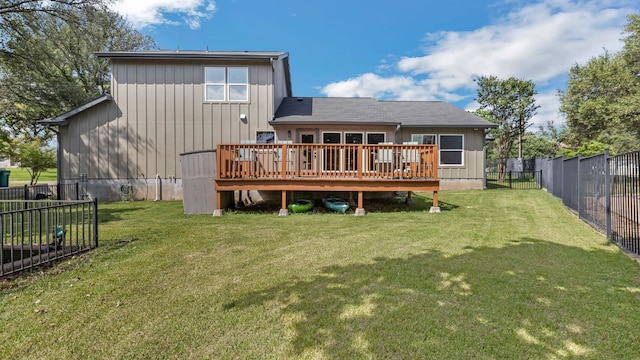 rear view of property featuring a fenced backyard, a yard, and a deck