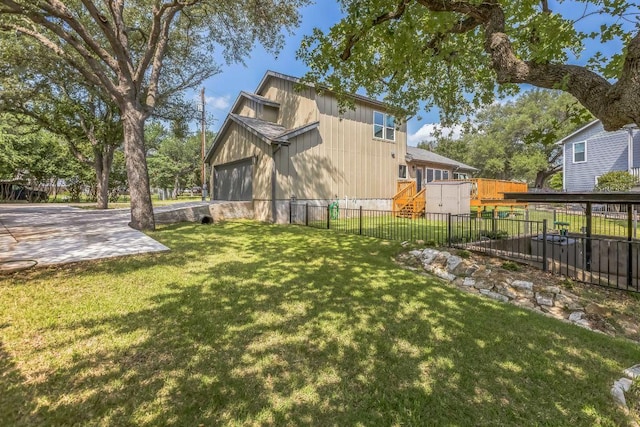 view of yard with fence and a garage