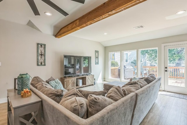 living room with visible vents, light wood-style floors, and plenty of natural light