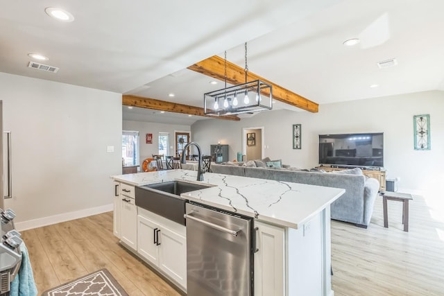 kitchen with visible vents, light wood-style floors, open floor plan, a sink, and dishwasher