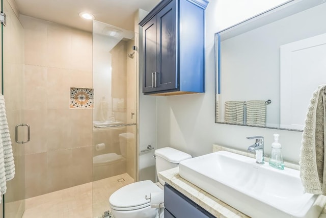bathroom featuring vanity, recessed lighting, a stall shower, and toilet