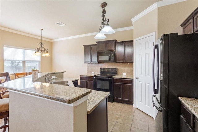kitchen featuring dark brown cabinets, a sink, tasteful backsplash, visible vents, and black appliances