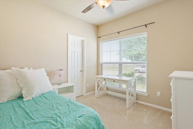 carpeted bedroom with baseboards and a ceiling fan