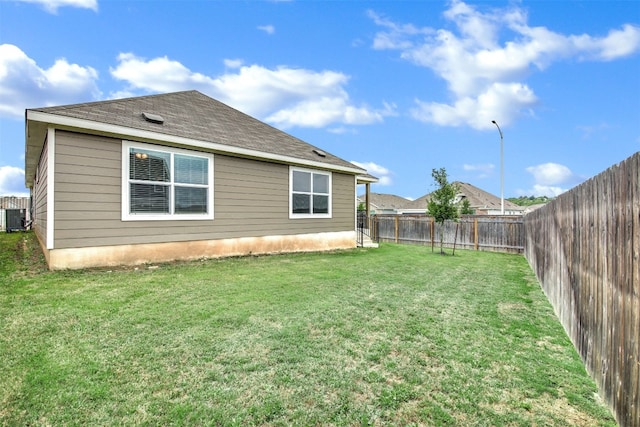 exterior space featuring a lawn, cooling unit, and a fenced backyard
