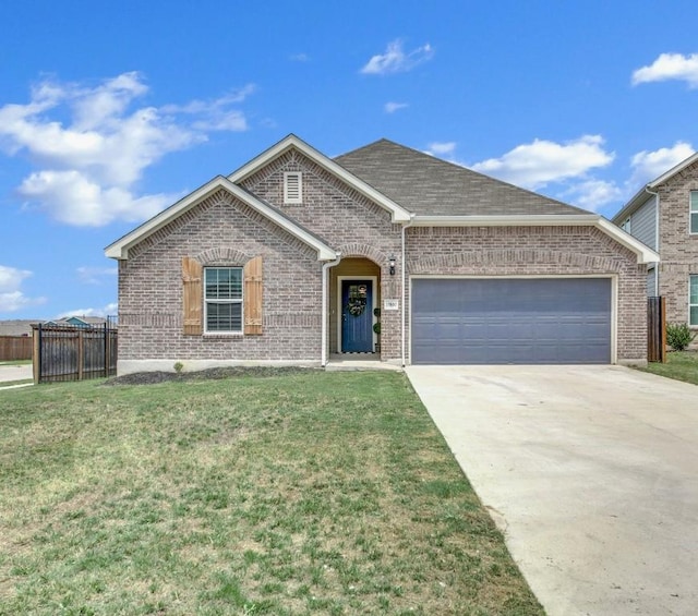 ranch-style home featuring an attached garage, concrete driveway, a front yard, and brick siding