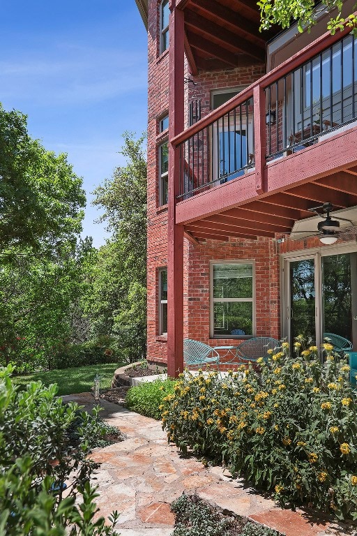 5705 Puccoon Cv, Austin, TX 78759 - view of property exterior with a balcony and brick siding