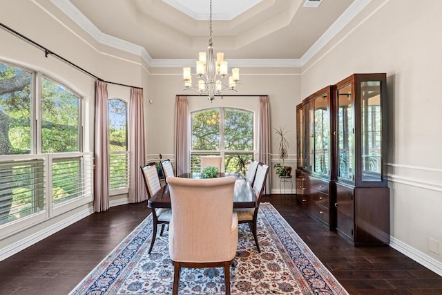 5705 Puccoon Cv, Austin, TX 78759 - dining room with a chandelier, plenty of natural light, dark wood-type flooring, a raised ceiling, and crown molding