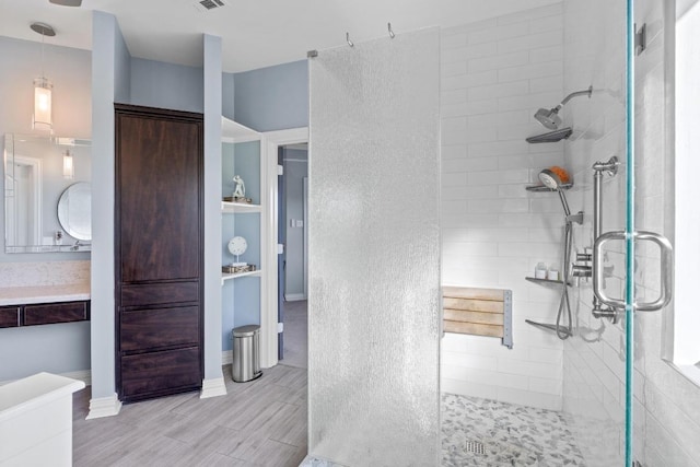 5705 Puccoon Cv, Austin, TX 78759 - bathroom with a walk in shower and wood finished floors