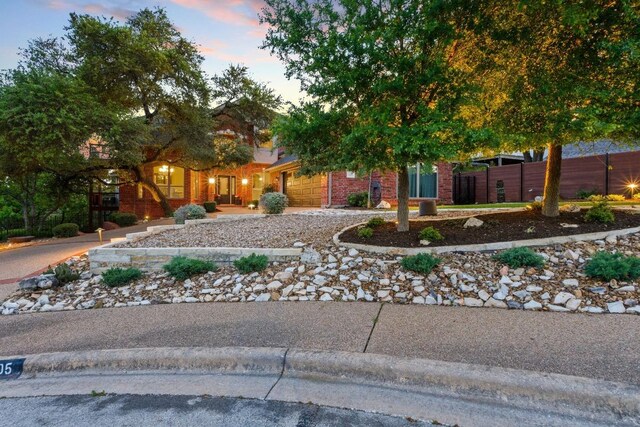 5705 Puccoon Cv, Austin, TX 78759 - view of front of property with curved driveway, an attached garage, fence, and brick siding