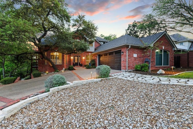 5705 Puccoon Cv, Austin, TX 78759 - ranch-style house featuring brick siding, a garage, driveway, and roof with shingles