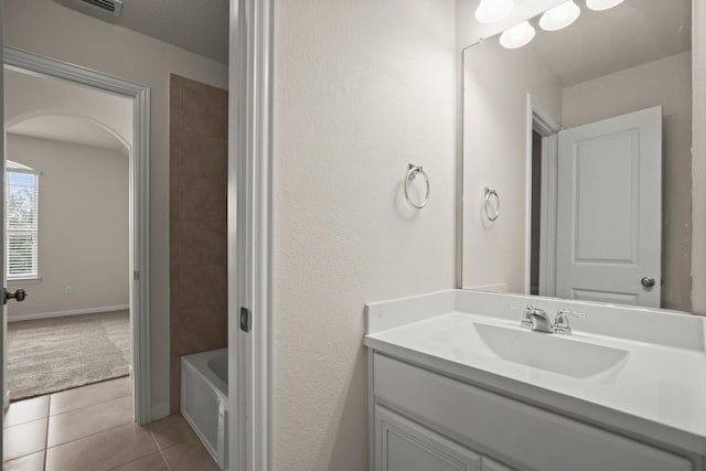 bathroom with tile patterned flooring and vanity