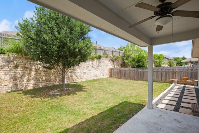 view of yard with a patio, a fenced backyard, and ceiling fan