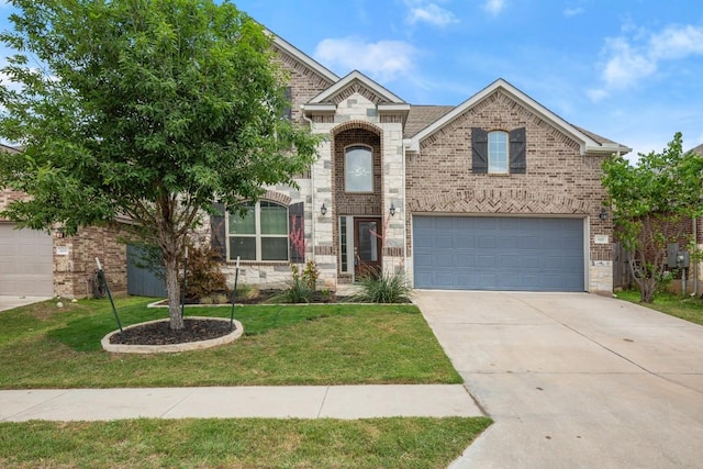 traditional-style house with a front lawn, stone siding, brick siding, concrete driveway, and an attached garage