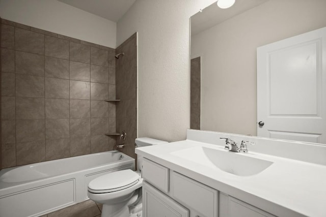 bathroom featuring a textured wall, tile patterned flooring, vanity, toilet, and shower / washtub combination