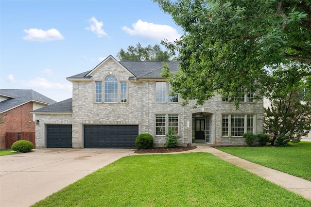 2045 Saint Andrews Dr, Round Rock, TX 78664 - view of front of property with concrete driveway, a front lawn, brick siding, an attached garage, and roof with shingles