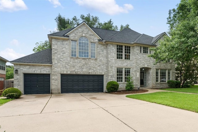 2045 Saint Andrews Dr, Round Rock, TX 78664 - view of front of property featuring driveway, brick siding, roof with shingles, and a front lawn