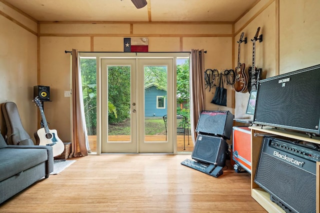 doorway with french doors, ceiling fan, and wood finished floors