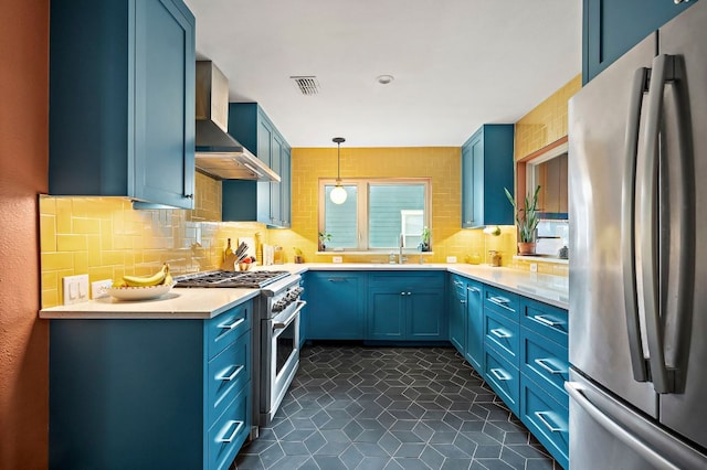 1516 Madison Ave, Austin, TX 78757 - kitchen with stainless steel appliances, wall chimney exhaust hood, blue cabinets, a sink, and backsplash